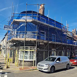 a car parked in front of a building under construction