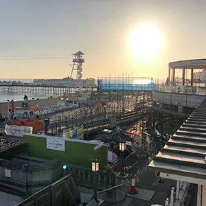 the sun is setting over a city with lots of buildings