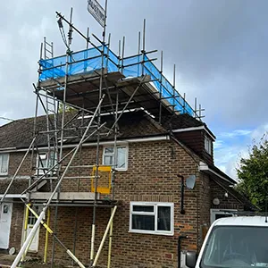 a house under construction with scaffolding on the roof